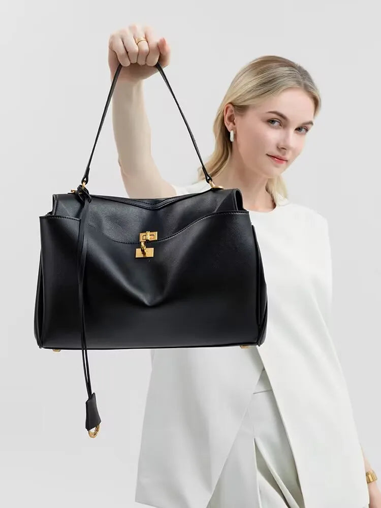 Elevate your style with this genuine leather women's tote bag. Featuring a distinctive gold buckle, this elegant handbag is perfect for commuting and adding a touch of sophistication to your look. -