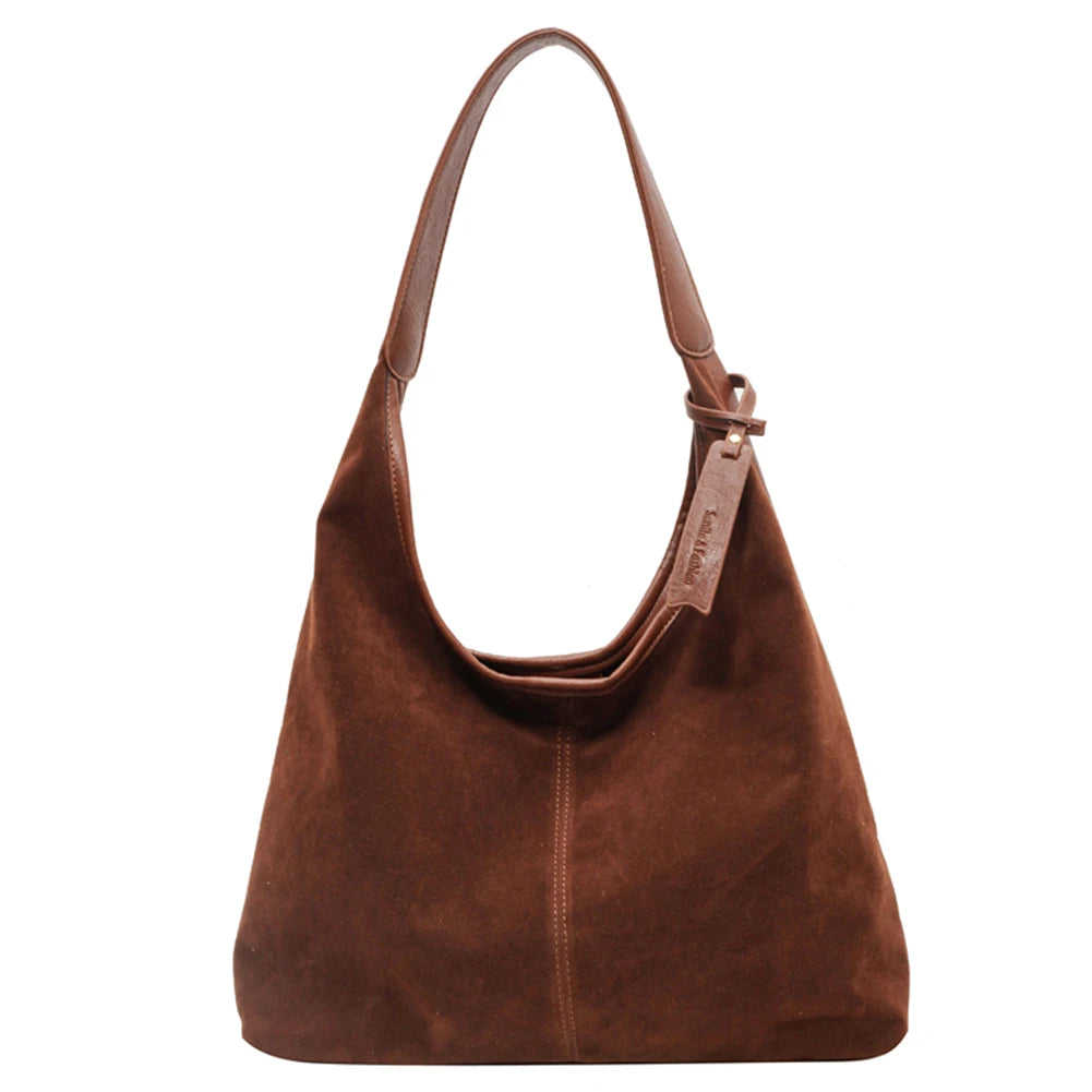Elevate your style with this vintage shoulder bag, featuring a solid color design and large capacity. Perfect for the autumn-winter season, this handbag offers both fashion and functionality for your everyday essentials. -