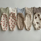 Keep your little ones comfy and cute in these organic cotton loose-fit baby pants—featuring playful tiger, bear, and floral prints perfect for boys and girls! -