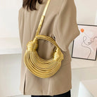 Make a statement with this gold luxury designer brand handwoven noodle bag. With a rope-knotted hobo design and a chic silver evening clutch, this bag is the epitome of high fashion and sophistication. -