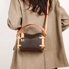 Make a statement with this luxurious and elegant box bag for women. Crafted from high-quality leather, this shoulder handbag features an elegant top-handle design, exuding sophistication and style for a classy finishing touch to your ensemble. -