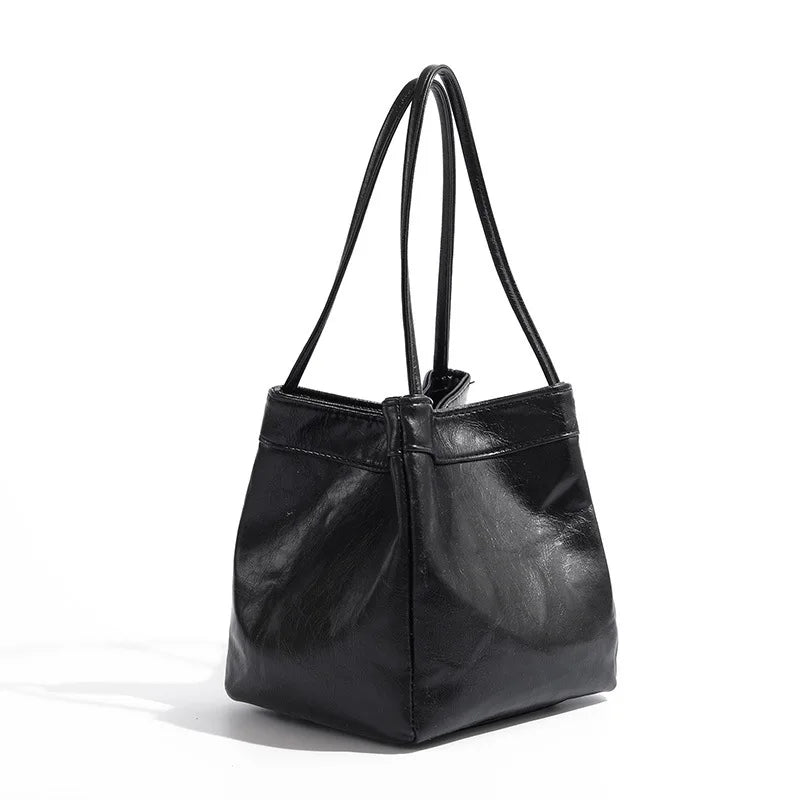 Stay on-trend with this bucket bag—a new fashion staple that offers simplicity, versatility, and a touch of classic style to elevate your wardrobe! -