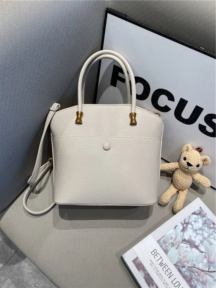 Elevate your style with this elegant tote bag. Crafted from genuine leather, this bag exudes sophistication and is the perfect accessory for a chic and classy look. -