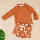 Make a splash in style with this fashionable and cute long-sleeve swimsuit for baby boys and girls—perfect for pool days and swim fun! -