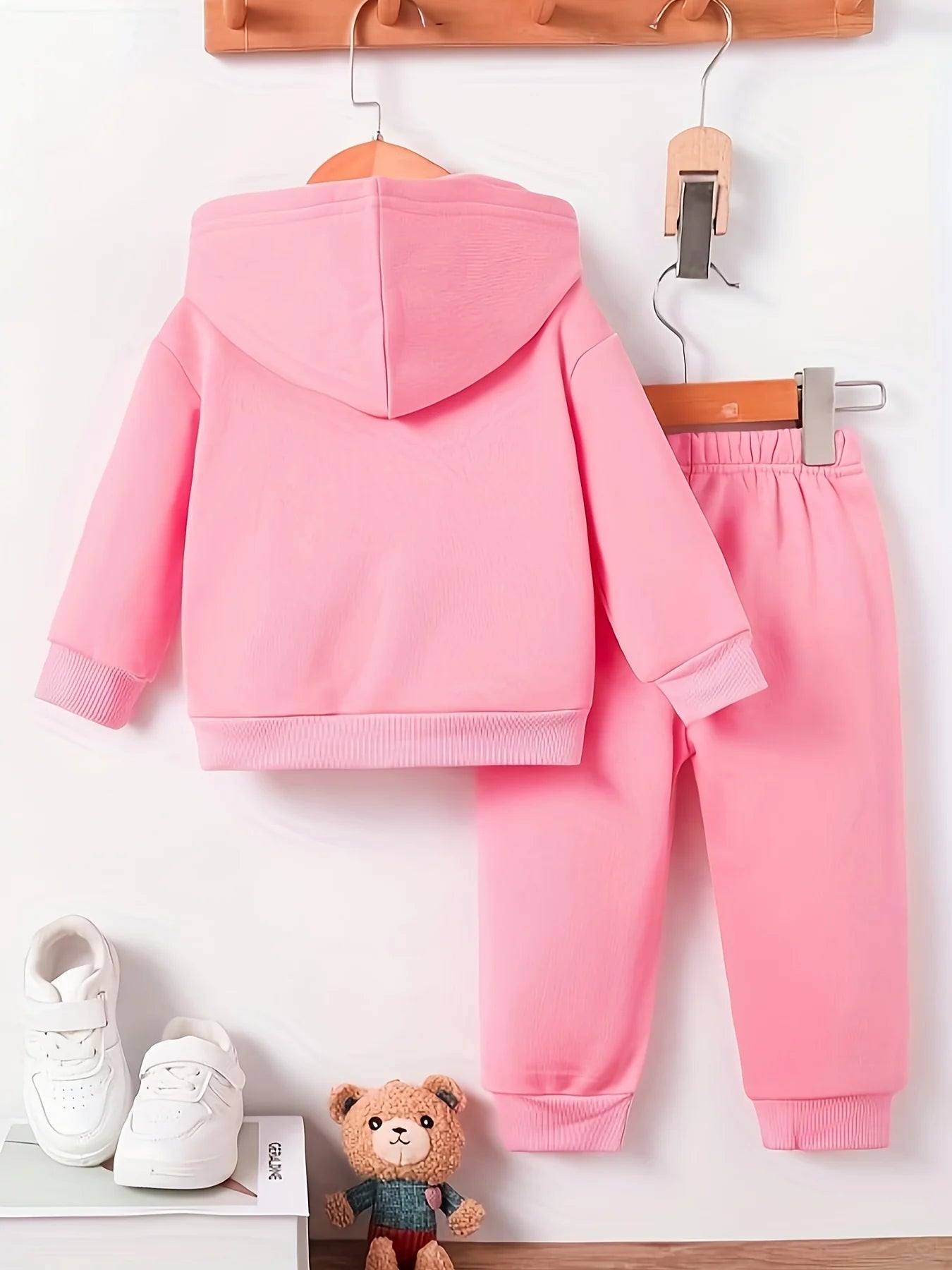 Keep your baby girl cozy and adorable with this fleece hoodie and pants set featuring a cute dog pattern print! -