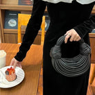 Make a statement with this gold luxury designer brand handwoven noodle bag. With a rope-knotted hobo design and a chic silver evening clutch, this bag is the epitome of high fashion and sophistication. -