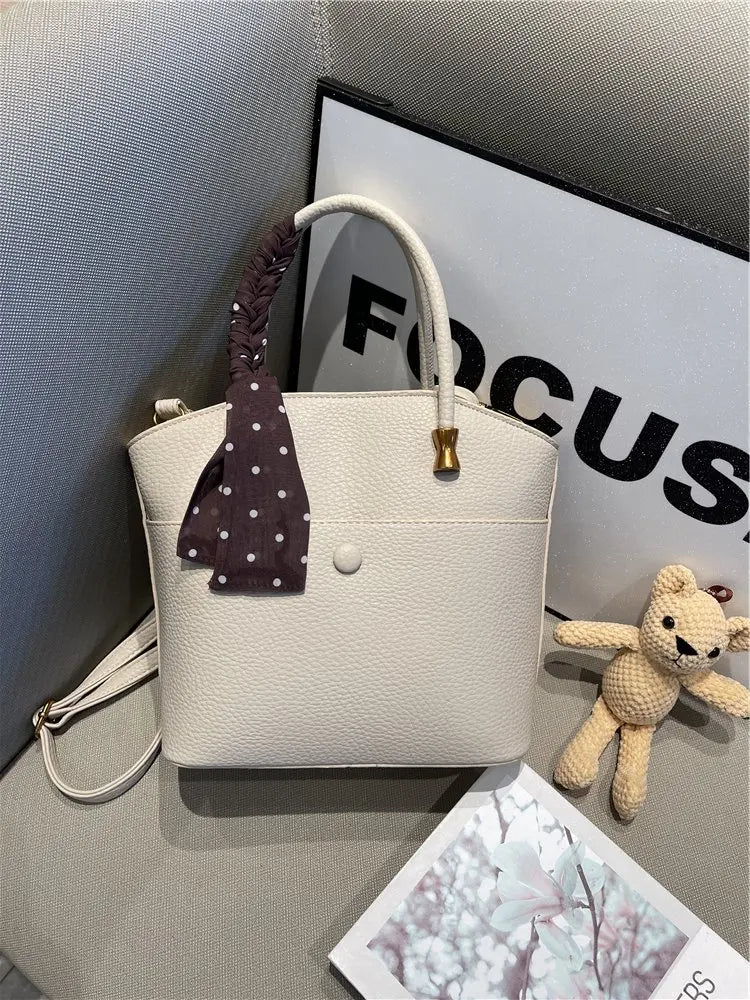 Elevate your style with this elegant tote bag. Crafted from genuine leather, this bag exudes sophistication and is the perfect accessory for a chic and classy look. -
