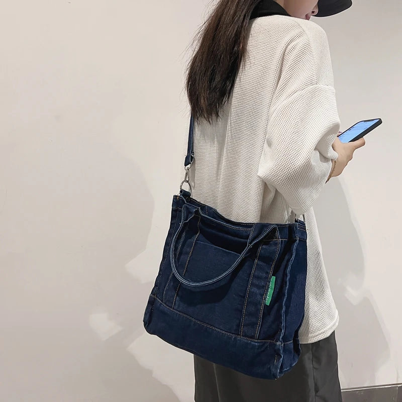 Elevate your casual look with this denim shoulder bag for women. Featuring a large design and zipper closure, this bag is perfect for shopping and everyday use, adding a touch of style to your outfit. -