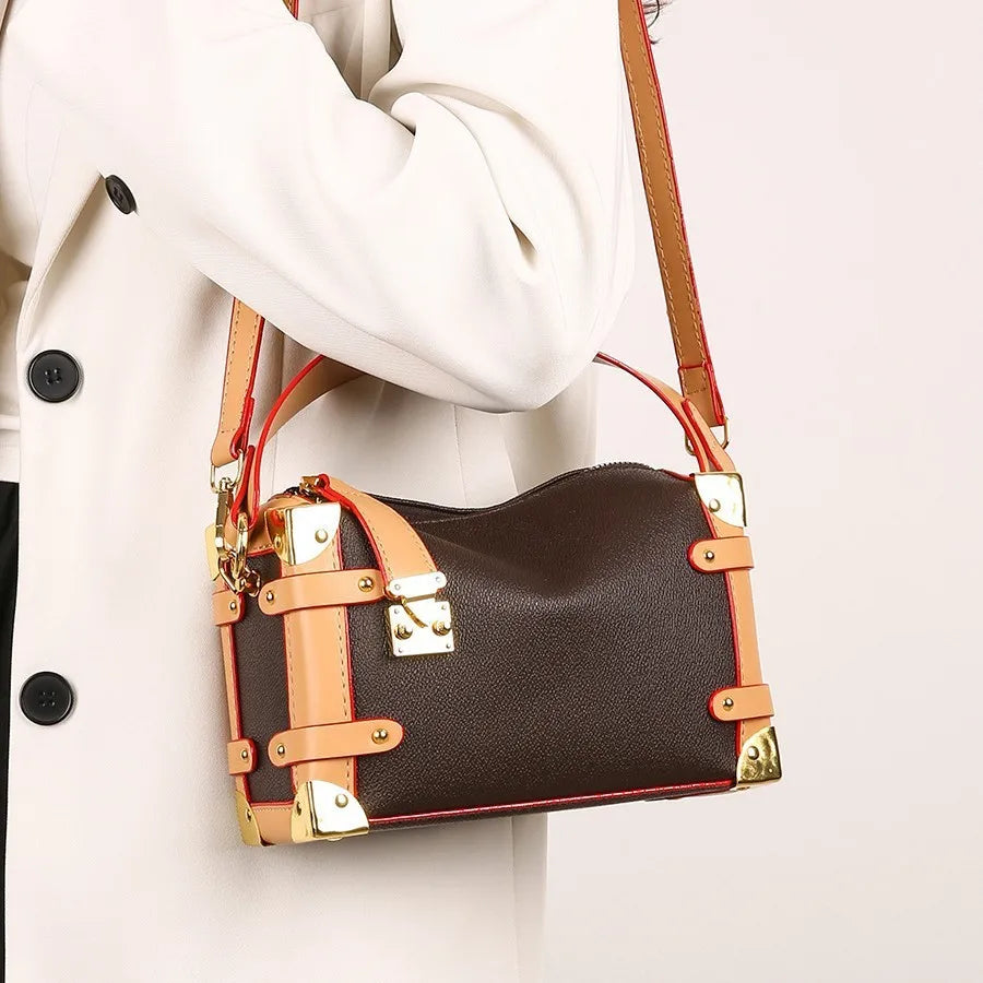 Make a statement with this luxurious and elegant box bag for women. Crafted from high-quality leather, this shoulder handbag features an elegant top-handle design, exuding sophistication and style for a classy finishing touch to your ensemble. -