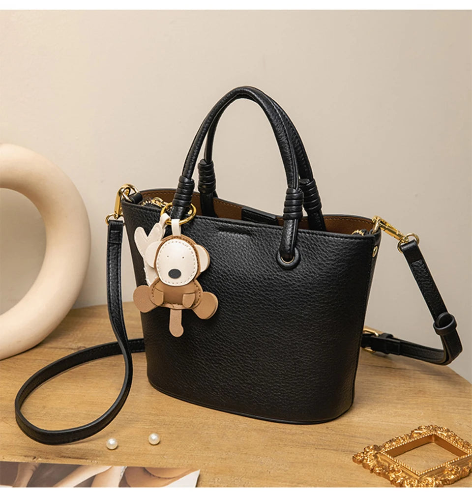 Upgrade your accessories with this new bucket bag for women. Featuring a fashionable and versatile design, this handheld bag is perfect for adding a chic and trendy touch to your look. -