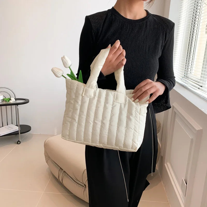 Carry your essentials in style with this large capacity and cotton-padded tote bag designed for ladies. Featuring a solid color and casual fashion, this bag is both practical and fashionable for everyday use. -