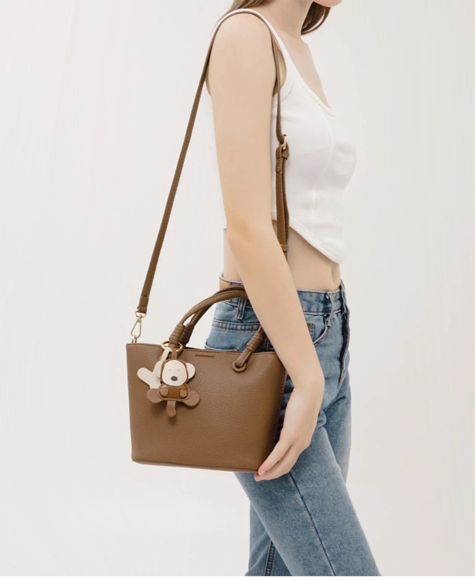 Upgrade your accessories with this new bucket bag for women. Featuring a fashionable and versatile design, this handheld bag is perfect for adding a chic and trendy touch to your look. -