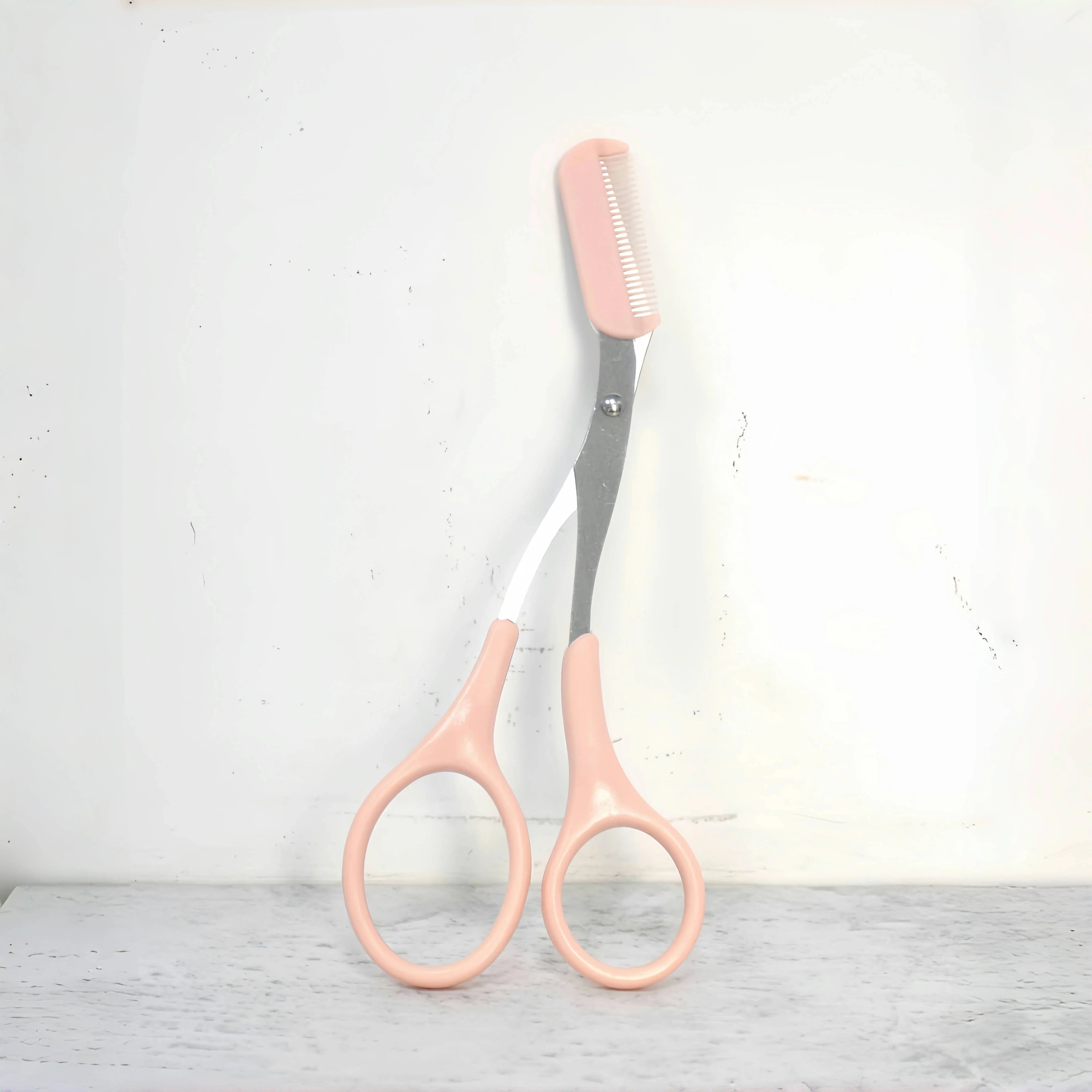 Eyebrow trimming scissors with built-in comb -