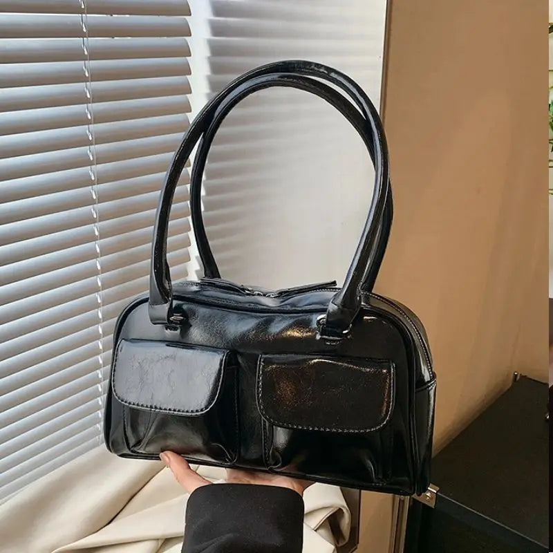 Accessorize stylishly with this black shoulder bag for women. This versatile handbag can be carried as a purse or a crossbody bag, making it a chic and practical choice for all occasions. -