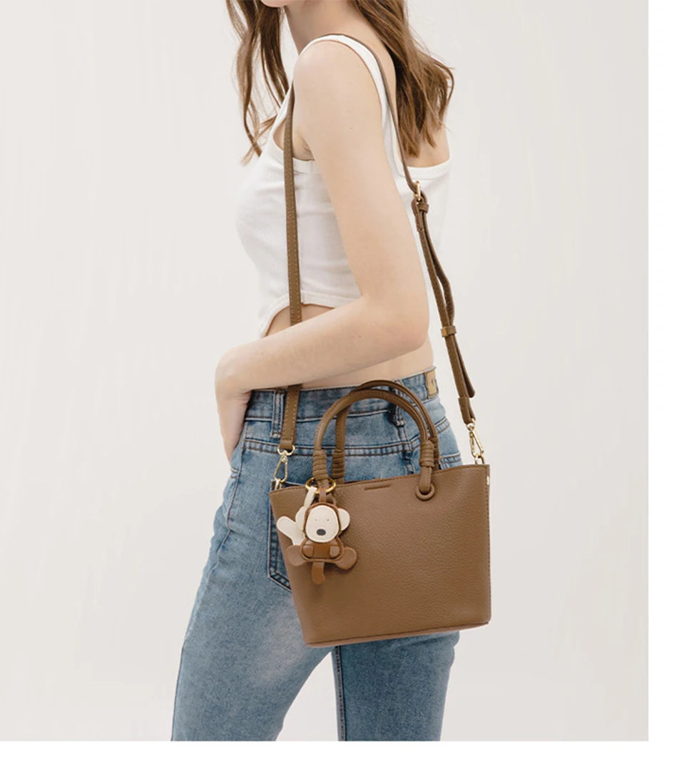 Upgrade your accessories with this new bucket bag for women. Featuring a fashionable and versatile design, this handheld bag is perfect for adding a chic and trendy touch to your look. -