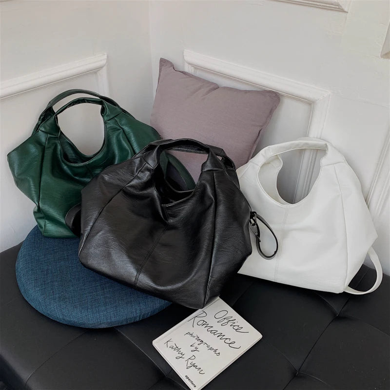 Make a stylish statement with these large shoulder bags designed for women. Crafted from soft leather, these fashionable handbags are perfect for adding a touch of sophistication to any outfit. -