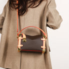Make a statement with this luxurious and elegant box bag for women. Crafted from high-quality leather, this shoulder handbag features an elegant top-handle design, exuding sophistication and style for a classy finishing touch to your ensemble. -