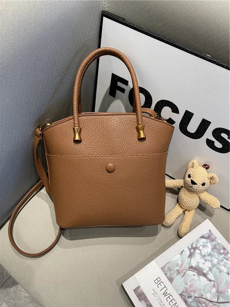 Elevate your style with this elegant tote bag. Crafted from genuine leather, this bag exudes sophistication and is the perfect accessory for a chic and classy look. -