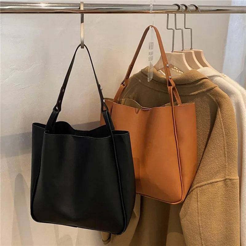 Elevate your style with these retro-inspired bucket shoulder bag made of real leather. -