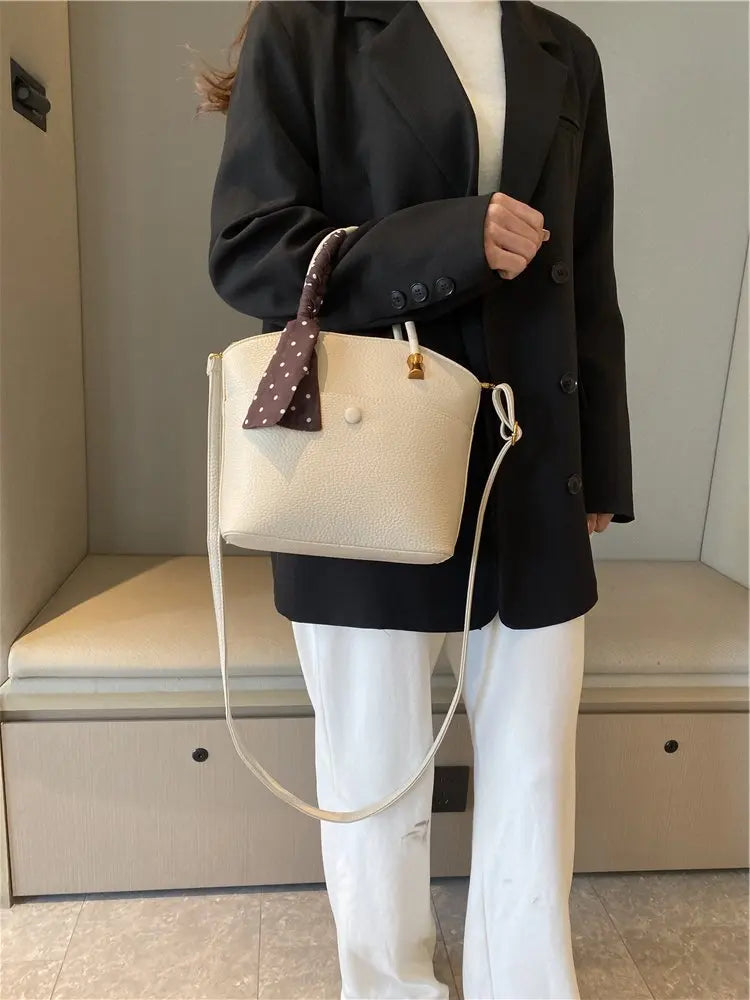 Elevate your style with this elegant tote bag. Crafted from genuine leather, this bag exudes sophistication and is the perfect accessory for a chic and classy look. -