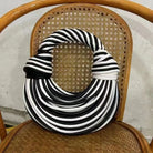 Make a statement with this gold luxury designer brand handwoven noodle bag. With a rope-knotted hobo design and a chic silver evening clutch, this bag is the epitome of high fashion and sophistication. -
