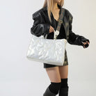 Stay on-trend with this fashion-forward large tote padded handbag featuring a designer quilted design. This stylish accessory is perfect for adding a touch of sophistication and elegance to your ensemble. -