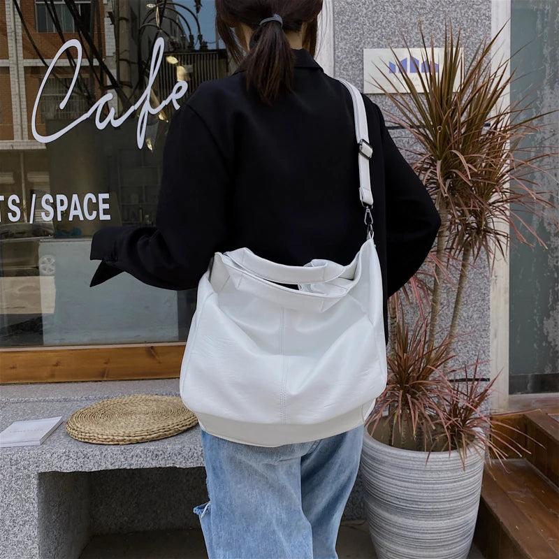 Make a stylish statement with these large shoulder bags designed for women. Crafted from soft leather, these fashionable handbags are perfect for adding a touch of sophistication to any outfit. -