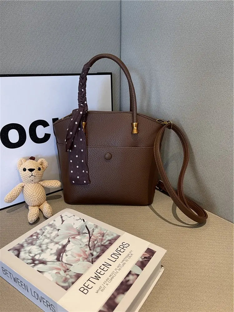 Elevate your style with this elegant tote bag. Crafted from genuine leather, this bag exudes sophistication and is the perfect accessory for a chic and classy look. -