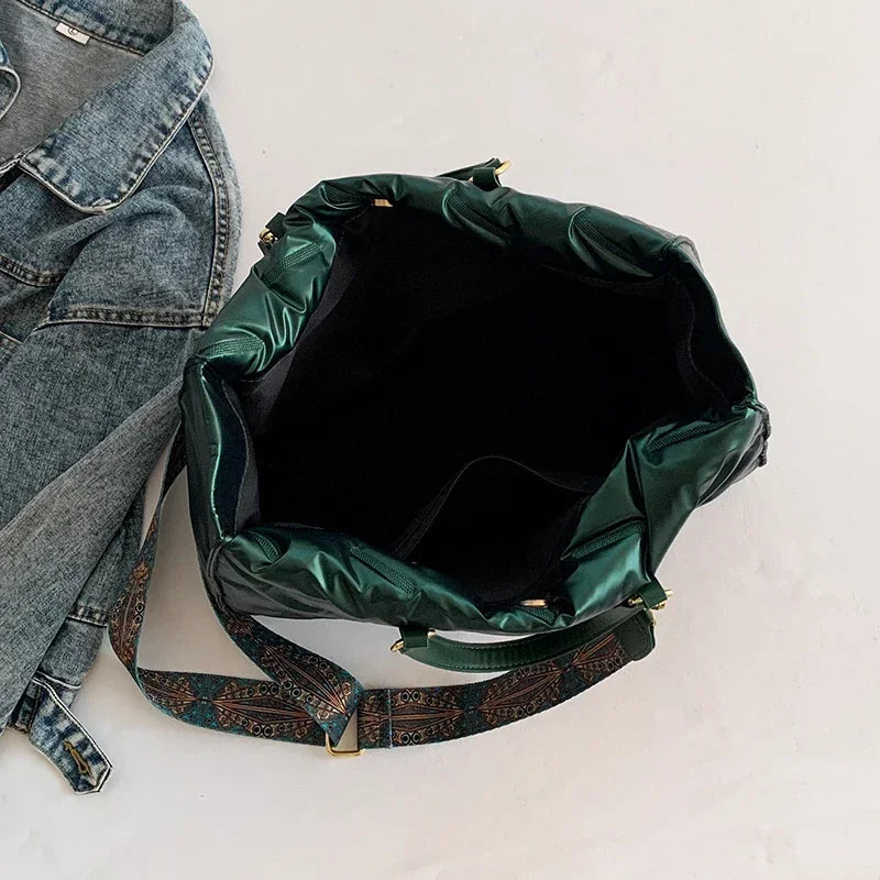 Stay on-trend with this fashion-forward large tote padded handbag featuring a designer quilted design. This stylish accessory is perfect for adding a touch of sophistication and elegance to your ensemble. -