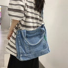 Elevate your casual look with this denim shoulder bag for women. Featuring a large design and zipper closure, this bag is perfect for shopping and everyday use, adding a touch of style to your outfit. -