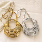 Make a statement with this gold luxury designer brand handwoven noodle bag. With a rope-knotted hobo design and a chic silver evening clutch, this bag is the epitome of high fashion and sophistication. -