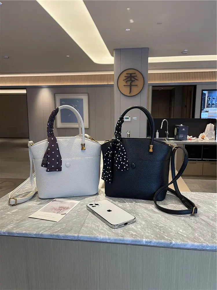 Elevate your style with this elegant tote bag. Crafted from genuine leather, this bag exudes sophistication and is the perfect accessory for a chic and classy look. -