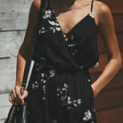Dress to impress in this sexy and stylish women's summer jumpsuit. Featuring a backless design, deep V-neckline, floral print, and strappy details, this romper is perfect for making a statement with your outfit! -