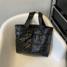 Stay stylish and organized with this fashion women's tote bag. Featuring a large capacity and cotton-padded design, this chic accessory is perfect for women who prioritize both style and functionality in their handbag. -