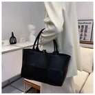 Make a fashion statement with this large capacity handbag. Crafted with stylish woven leather, this tote bag is perfect for adding a touch of elegance to your everyday outfit. -