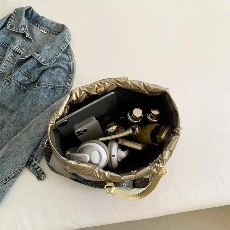Stay on-trend with this fashion-forward large tote padded handbag featuring a designer quilted design. This stylish accessory is perfect for adding a touch of sophistication and elegance to your ensemble. -