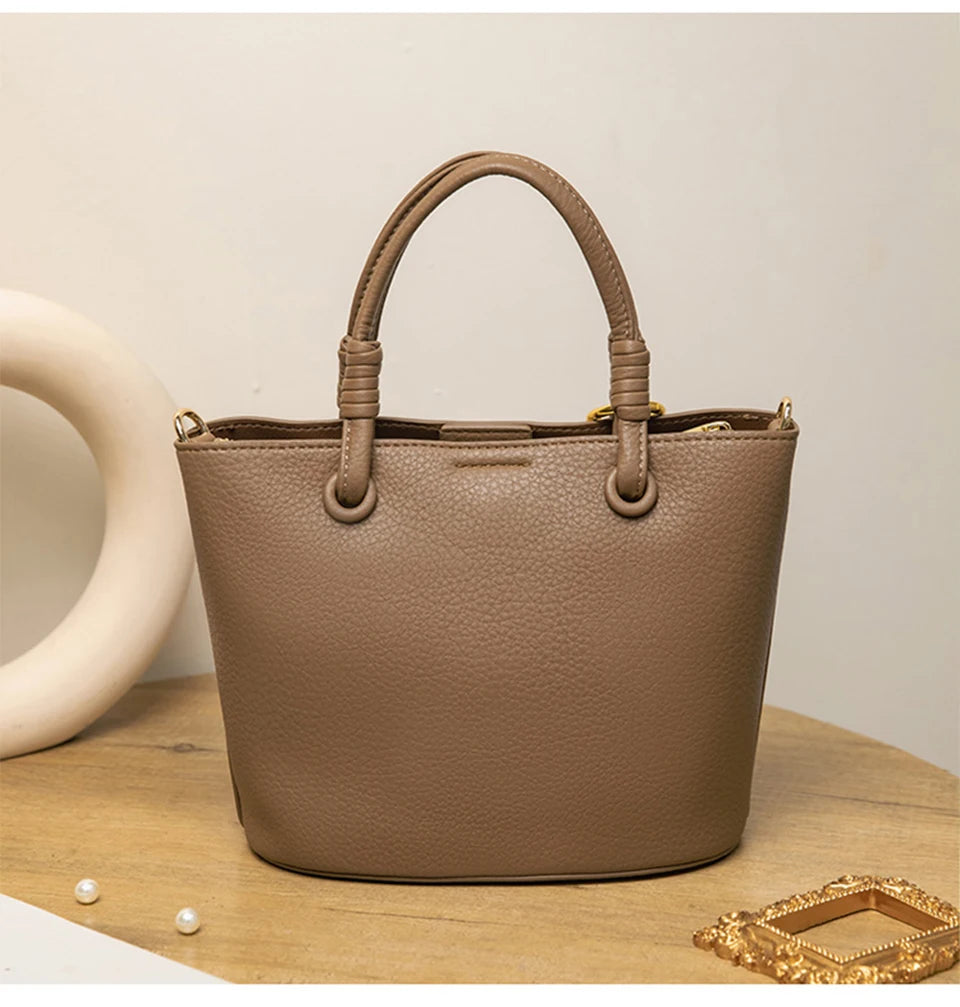 Upgrade your accessories with this new bucket bag for women. Featuring a fashionable and versatile design, this handheld bag is perfect for adding a chic and trendy touch to your look. -
