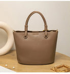 Upgrade your accessories with this new bucket bag for women. Featuring a fashionable and versatile design, this handheld bag is perfect for adding a chic and trendy touch to your look. -