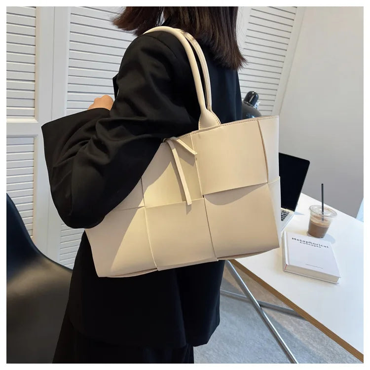 Make a fashion statement with this large capacity handbag. Crafted with stylish woven leather, this tote bag is perfect for adding a touch of elegance to your everyday outfit. -