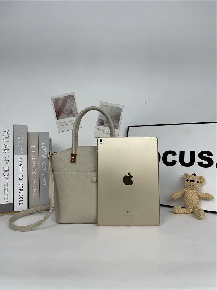 Elevate your style with this elegant tote bag. Crafted from genuine leather, this bag exudes sophistication and is the perfect accessory for a chic and classy look. -