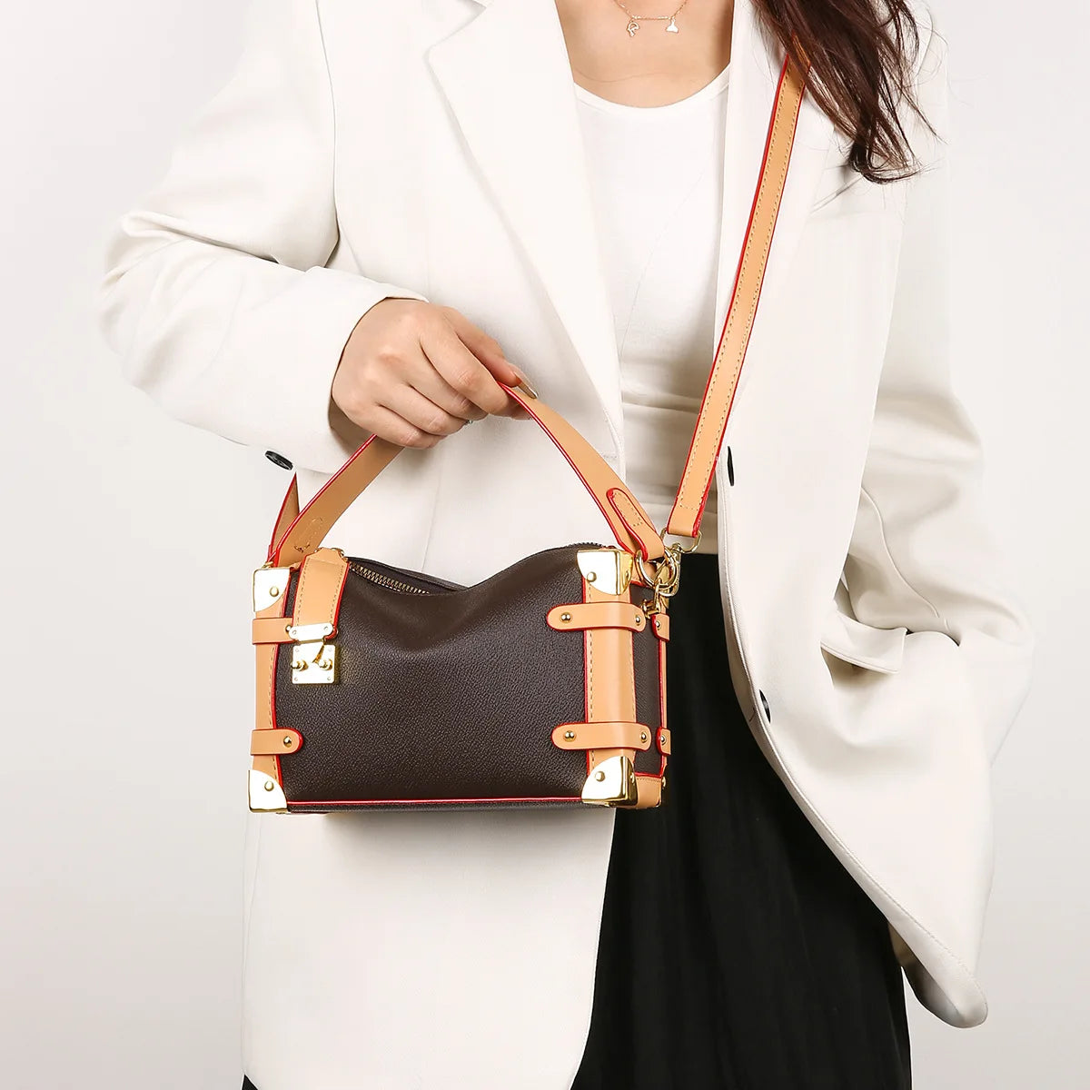 Make a statement with this luxurious and elegant box bag for women. Crafted from high-quality leather, this shoulder handbag features an elegant top-handle design, exuding sophistication and style for a classy finishing touch to your ensemble. -