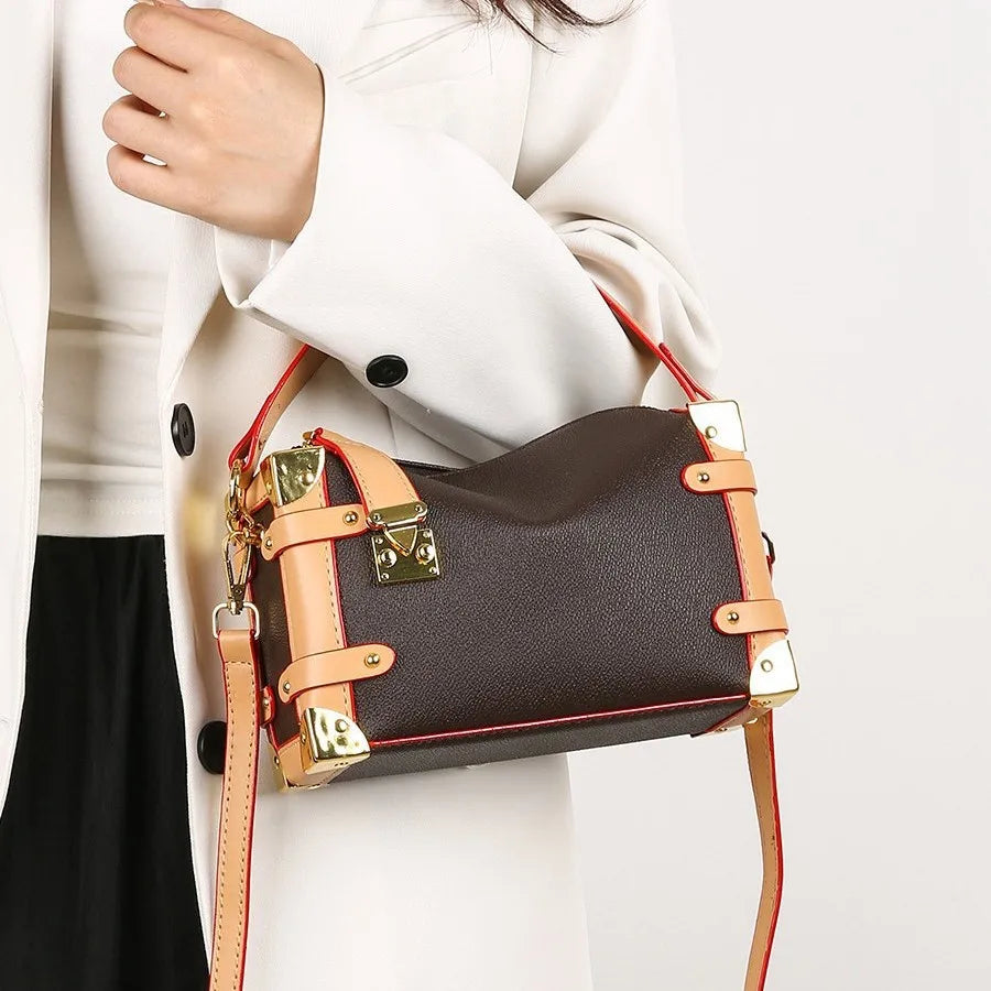 Make a statement with this luxurious and elegant box bag for women. Crafted from high-quality leather, this shoulder handbag features an elegant top-handle design, exuding sophistication and style for a classy finishing touch to your ensemble. -