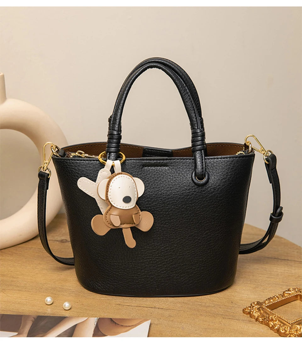 Upgrade your accessories with this new bucket bag for women. Featuring a fashionable and versatile design, this handheld bag is perfect for adding a chic and trendy touch to your look. -