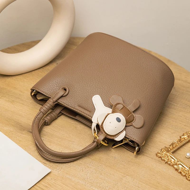 Upgrade your accessories with this new bucket bag for women. Featuring a fashionable and versatile design, this handheld bag is perfect for adding a chic and trendy touch to your look. -
