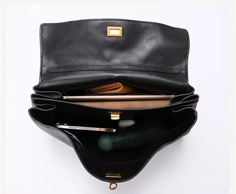 Elevate your style with this genuine leather women's tote bag. Featuring a distinctive gold buckle, this elegant handbag is perfect for commuting and adding a touch of sophistication to your look. -