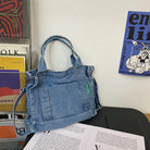 Elevate your casual look with this denim shoulder bag for women. Featuring a large design and zipper closure, this bag is perfect for shopping and everyday use, adding a touch of style to your outfit. -