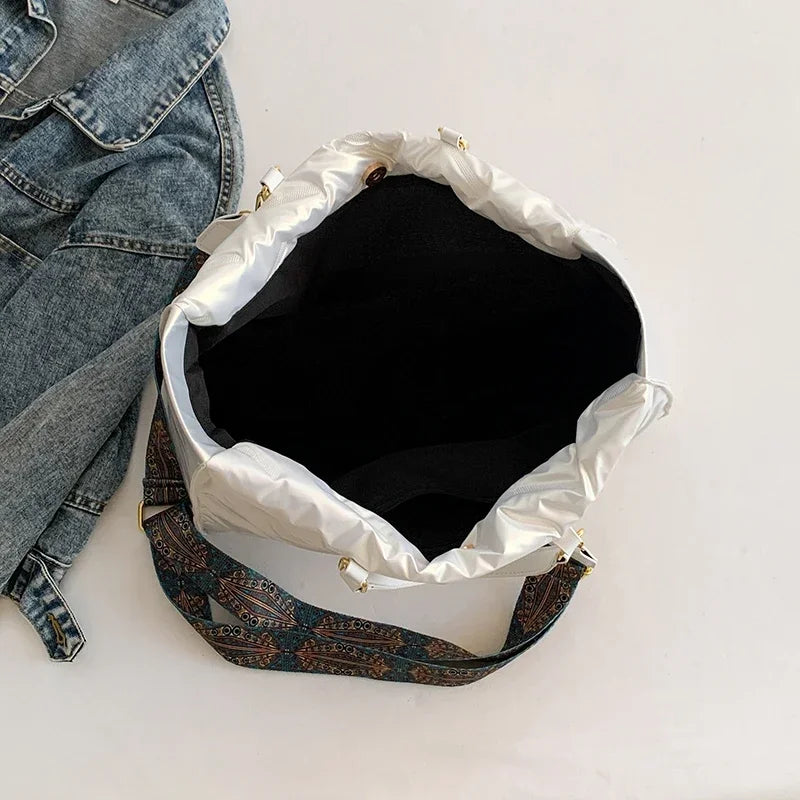 Stay on-trend with this fashion-forward large tote padded handbag featuring a designer quilted design. This stylish accessory is perfect for adding a touch of sophistication and elegance to your ensemble. -