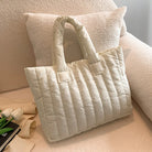 Carry your essentials in style with this large capacity and cotton-padded tote bag designed for ladies. Featuring a solid color and casual fashion, this bag is both practical and fashionable for everyday use. -