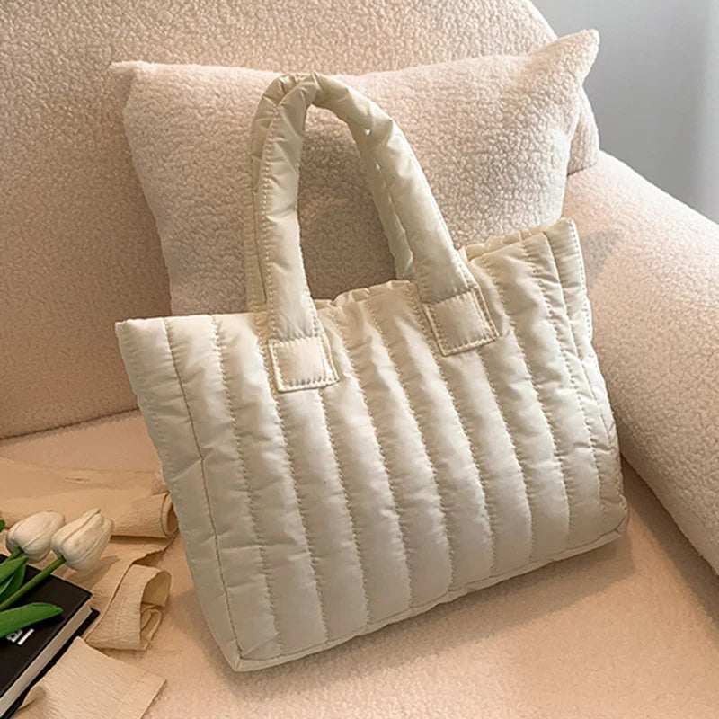 Carry your essentials in style with this large capacity and cotton-padded tote bag designed for ladies. Featuring a solid color and casual fashion, this bag is both practical and fashionable for everyday use. -