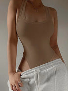 Achieve a hot and sexy look with this sleeveless knit bodysuit featuring an off-shoulder halter design. Perfect for making a stylish and alluring statement! -